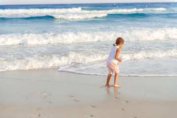 happy  little girl have fun and joy time at beautiful beach