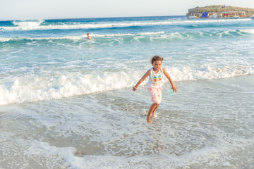happy  little girl have fun and joy time at beautiful beach