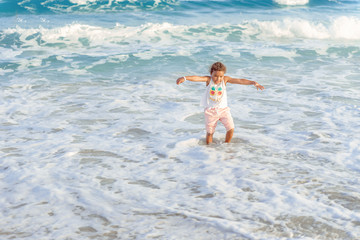 happy  little girl have fun and joy time at beautiful beach