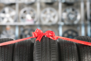 Car tires tied with red ribbon in auto store
