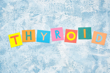 Word THYROID on color background