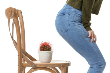 Young woman and chair with cactus on white background. Hemorrhoids concept