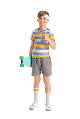 Sporty little boy with skateboard on white background