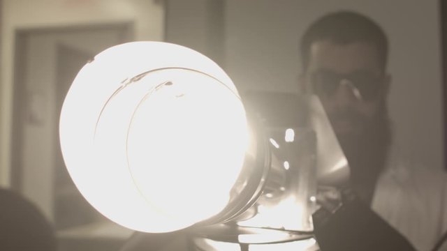 Scientist doctor engineer man creates light gun contraption device invention CGI VFX editing