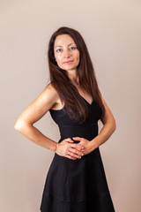 Fototapeta premium pretty women with long hair in black dress studio portrait.