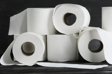 Rolls of toilet paper on wooden background