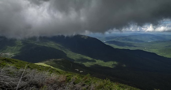 Time lapse midway up mount Washington just below cloud level in New Hampshire USA. Clouds flying overhead with view of the road up mtn far below. Includes 2 versions, one tilting up and 1 stationary.
