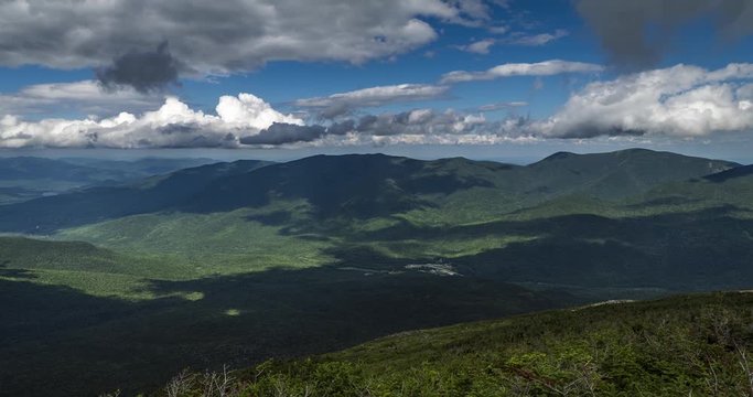 Time lapse midway up mount Washington just below cloud level in New Hampshire USA. Clouds flying overhead with a road far below. Includes 2 versions, one static and 1 tilting down.
