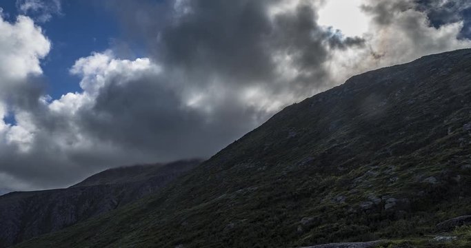 Time lapse midway up mount Washington in New Hampshire USA. Facing up at the mountain while clouds fly past and the sun moves.