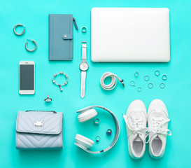 Fototapeta na wymiar Female accessories with laptop, headphones and mobile phone on color background