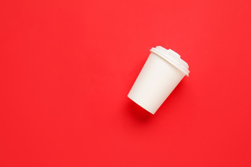 Takeaway cup for drink on color background