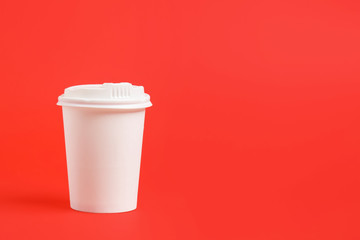 Takeaway cup for drink on color background