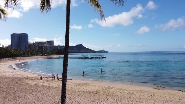 Cinematic aerial drone videos of vacant Waikiki Beach, amidst the backdrop of iconic Diamond Head.