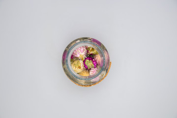 Wild flowers tea on a bottle seen from above