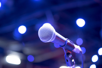 microphone in concert hall, restaurant or conference room blurred background