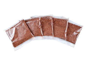 Flax porridge in a transparent plastic bags isolated on a white background. Top view.