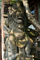 Sculpture and carved antique deity angel god of hindu statue balinese style in Pura Dalem Agung Padangtegal in Mandala Suci Wenara Wana or Monkey Forest at Ubud city in Bali, Indonesia