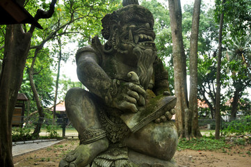 Fototapeta na wymiar Art sculpture and carved antique deity angel god of hindu statue balinese style in Mandala Suci Wenara Wana or Ubud Sacred Monkey Forest Sanctuary at Ubud city in Bali, Indonesia