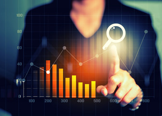 Businesswomen hand touching search engine optimization financial graph data and stock market...
