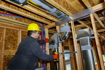 Workers making final air duct conditioning HVAC system stands for heating