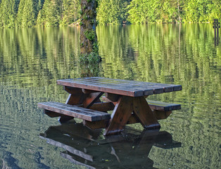 Picnic bench in a flooded lake.