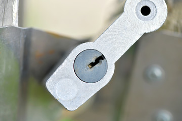Old lock in a wooden gate, close-up: a key hole