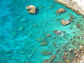 Fototapeta na wymiar Beautiful turquoise ocean water with white rock, Zakynthos island, Greece. Sea water background with bright texture.
