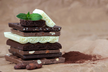 Different kinds of chocolates with nuts cocoa powder and mint