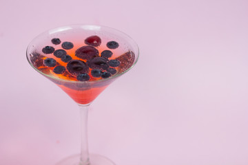 Berry cocktail with a pink background