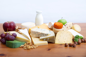 Heap of high protein foods, assorted cheeses, milk, fruits and nuts. Gourmet and healthy nutrition concept