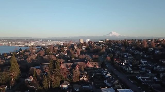 Aerial View Of Annie Wright Schools In Tacoma, Washington On A Sunny Morning With Distant View Of Snowy Mountain - parallax slow