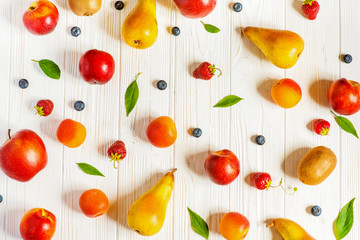 Pattern of fruits and berries on white.