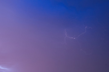 Lightning against a pink blue sky