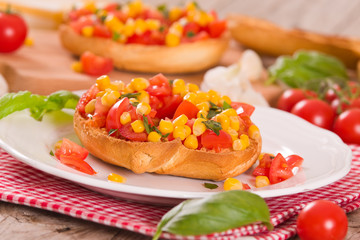 Friselle with tomatoes and mais.
