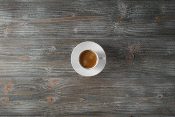 White coffee cup on a wooden table, flat lay. Old wooden table.