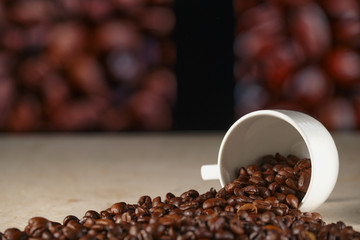 An empty Cup of coffee on the marble table. Coffee beans on the table, blurred background. C lose- up