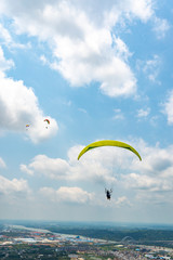 Outdoor city green hill scenery and paragliding