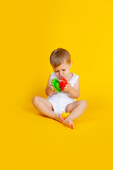 a little boy sits and tries to connect the details from an educational game such as a pyramid