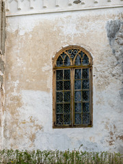Fototapeta na wymiar arched windows on a white church wall
