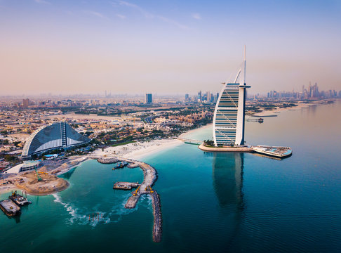 Dubai, United Arab Emirates - June 5, 2019: Burj Al Arab luxury hotel and Dubai marina skyline in the background