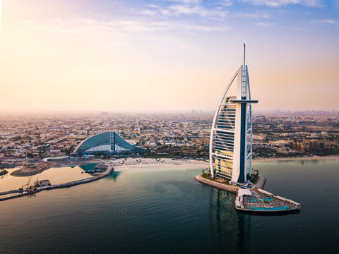 Dubai, United Arab Emirates - June 5, 2019: Dubai seaside skyline and Burj Al Arab luxury hotel at sunrise