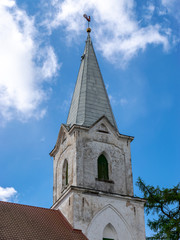 Fototapeta premium a white Lutheran church tower against the sky