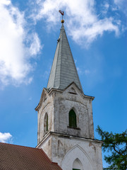 Fototapeta na wymiar a white Lutheran church tower against the sky