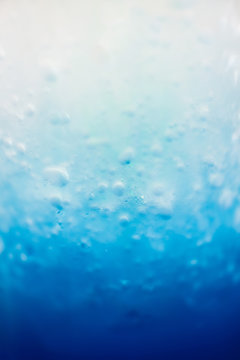 Blur image for the background of Blue Soda In the photo, the soda is still on the top of the glass to mix with the blue syrup on the bottom of the glass.