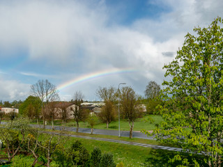 colorful landscape with a rainbow over the trees, a small village view