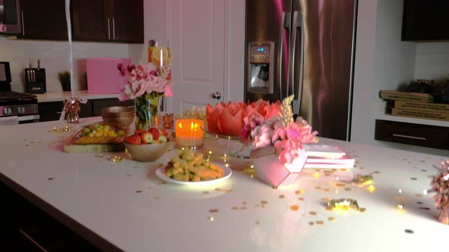 Kitchen decorated with birthday things, balloons, candles, confetti and cake.