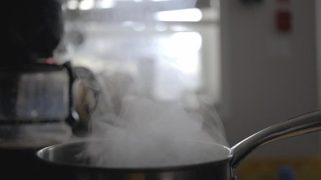 Steam Rising Up From The Cooking Saucepan In The Kitchen. - close up shot