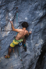 A strong man climbs a rock, Rock climbing in Turkey.