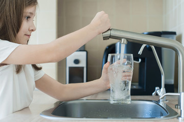 Child open water tap. Kitchen faucet. Glass of clean water. Pouring fresh drink. Hydration. Healthy...