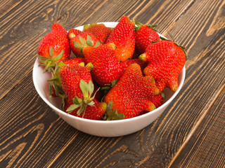 Ugly food: unusual strawberries in a plate